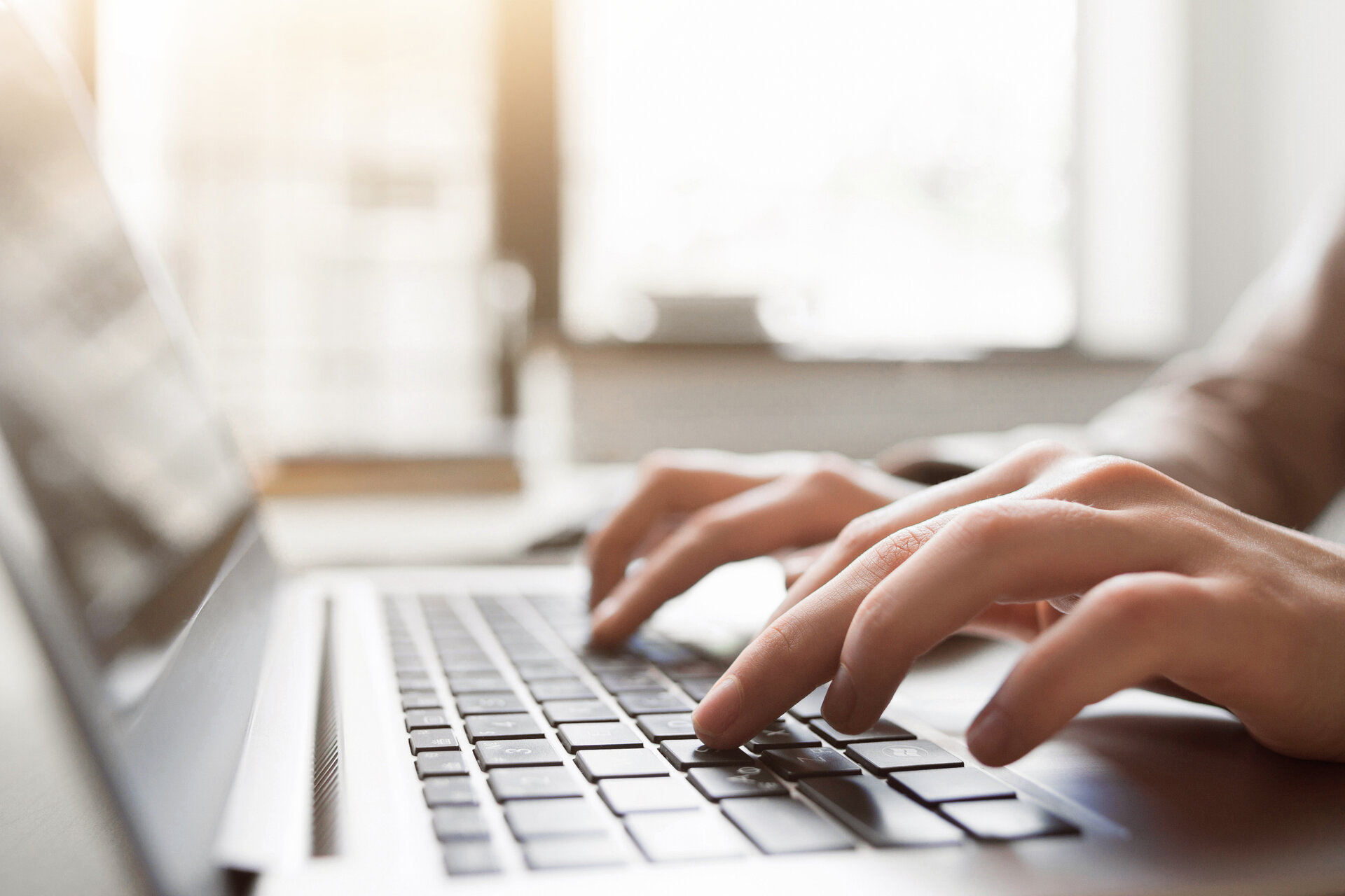 Person typing on keyboard